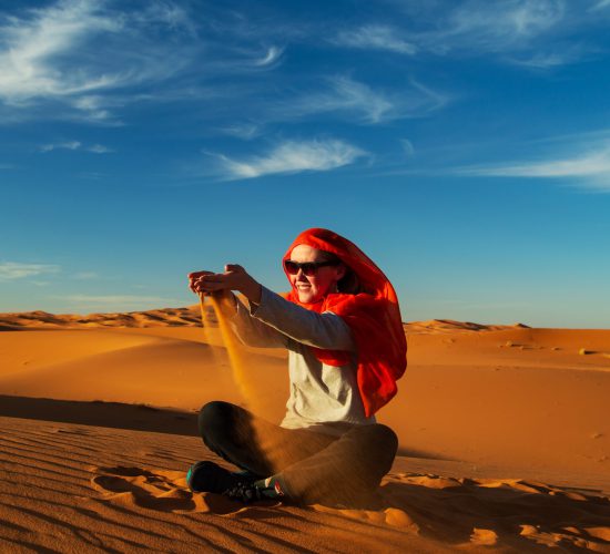 Girl,Plays,With,Sand,In,The,Sahara,Desert.,Erg,Chebbi,
