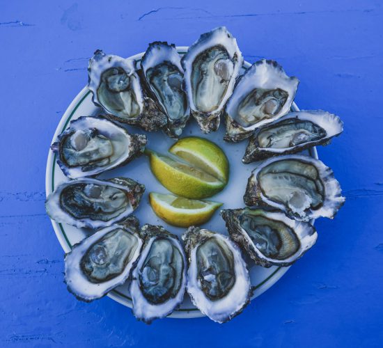 Dish,Of,Oysters,On,A,Blue,Table