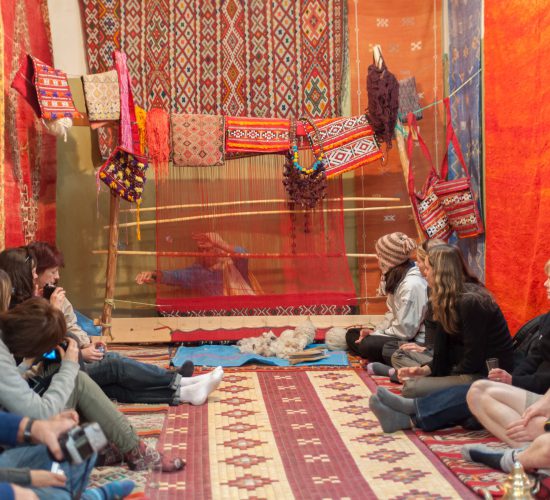 Ouarzazate,,Morocco,-,25,Nov:,Tourists,Watching,Moroccan,Woman,Weaving