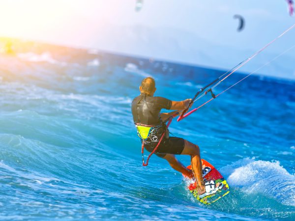 Man,Kitesurfer,Riding,The,Waves,With,Strong,Winds.,Bright,Sunny